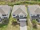 Aerial view of a two-story home featuring a manicured lawn, paved driveway, and attached garage at 38152 Cobble Creek Blvd, Zephyrhills, FL 33540