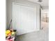 Hallway with double doors to a closet and an open door with a view of the second-floor railing at 38152 Cobble Creek Blvd, Zephyrhills, FL 33540