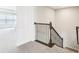 Carpeted staircase with decorative wrought iron railing leading to the upper level at 38152 Cobble Creek Blvd, Zephyrhills, FL 33540