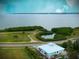 Stunning aerial view showcasing a waterfront home, a scenic pond, and coastal landscape at 406 Shore W Dr, Oldsmar, FL 34677