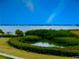 Picturesque view of a tranquil pond surrounded by lush greenery and scenic waterfront backdrop at 406 Shore W Dr, Oldsmar, FL 34677