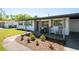 Inviting front porch with rocking chairs and lovely landscaping at 4636 W Bay Court Ave, Tampa, FL 33611