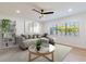 Cozy living room with modern sofa, area rug, and window bringing in natural light at 4636 W Bay Court Ave, Tampa, FL 33611