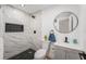 This renovated bathroom features stylish black and white tiling and modern fixtures at 507 Clearfield Rd, Brandon, FL 33511