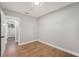 This bedroom features wood-look floors and easy access to the en suite bathroom at 507 Clearfield Rd, Brandon, FL 33511