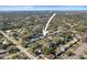 An aerial view of the home, showing its location within a residential neighborhood near a pond and city at 6044 Dartmouth N Ave, St Petersburg, FL 33710