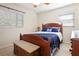 Cozy bedroom features a wooden bed frame, ceiling fan, and windows for natural light at 6044 Dartmouth N Ave, St Petersburg, FL 33710