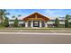 A spacious community clubhouse offers residents gathering space and is surrounded by lush landscaping and mature trees at 6127 164Th E Ave, Parrish, FL 34219