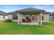 Covered back patio with outdoor seating, perfect for relaxing and entertaining guests at 6127 164Th E Ave, Parrish, FL 34219