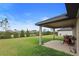 Spacious backyard with covered patio, well-maintained lawn, and beautiful landscaping at 6127 164Th E Ave, Parrish, FL 34219