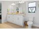 Bathroom with double sinks, granite countertops, and modern fixtures at 6127 164Th E Ave, Parrish, FL 34219