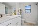 Bathroom featuring a white vanity with marble counter, a shelf, and a window at 6127 164Th E Ave, Parrish, FL 34219