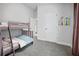 A bedroom featuring carpeted floors, bunk beds, and a window with blinds and brown curtains at 6127 164Th E Ave, Parrish, FL 34219