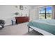 Spacious bedroom with stylish decor, dresser, and large window overlooking the lush outdoors at 6127 164Th E Ave, Parrish, FL 34219