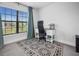 Bedroom features a window, a desk with chair, carpeted floors and blue curtains at 6127 164Th E Ave, Parrish, FL 34219