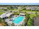 An aerial view of the community pool, clubhouse, and pond provides residents with relaxation and recreation opportunities at 6127 164Th E Ave, Parrish, FL 34219