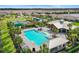 An aerial view of the community pool and clubhouse, alongside the playground and tennis courts, offer fun for everyone at 6127 164Th E Ave, Parrish, FL 34219