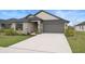Lovely single-story home with a two-car garage and meticulously landscaped front yard at 6127 164Th E Ave, Parrish, FL 34219