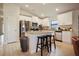 Bright kitchen features white cabinets, stainless steel appliances, granite counters, and island with seating at 6127 164Th E Ave, Parrish, FL 34219
