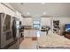 Kitchen with stainless appliances, white cabinets, granite counters and island with vase of purple flowers at 6127 164Th E Ave, Parrish, FL 34219