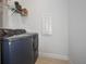 Modern laundry room featuring a front-load washer and dryer and convenient shelving at 6127 164Th E Ave, Parrish, FL 34219