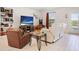 Cozy living room with comfortable seating, TV, and bright natural light from the windows at 6127 164Th E Ave, Parrish, FL 34219