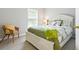 Comfortable bedroom features natural light, a queen bed, and accent chair at 6134 Fishhawk Crossing Blvd, Lithia, FL 33547