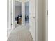 Hallway with neutral carpet and white doors leading to various rooms at 6134 Fishhawk Crossing Blvd, Lithia, FL 33547