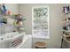 Bright laundry room with shelving and large window with natural light at 6134 Fishhawk Crossing Blvd, Lithia, FL 33547