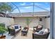 Cozy screened patio with comfortable seating and a small table at 6134 Fishhawk Crossing Blvd, Lithia, FL 33547