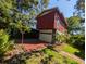 Two-story home with an attached garage, red brick driveway, and green landscaping at 6144 10Th S Ave, Gulfport, FL 33707