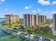 Aerial view of the condo building and boat docks, showcasing waterfront living at its finest at 690 Island Way # 1003, Clearwater Beach, FL 33767