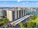 Aerial view showcasing the condo building, covered parking, and well-maintained landscaping at 690 Island Way # 1003, Clearwater Beach, FL 33767