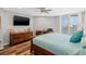 Bedroom featuring wood floors, a ceiling fan, and beautiful waterfront views at 690 Island Way # 1003, Clearwater Beach, FL 33767