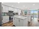 Bright, updated kitchen features white cabinets, stainless appliances, and a large center island at 690 Island Way # 1003, Clearwater Beach, FL 33767