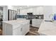 Bright kitchen with white cabinets, stone countertops and stainless appliances at 690 Island Way # 1003, Clearwater Beach, FL 33767
