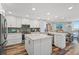 Bright, updated kitchen features white cabinets, stainless appliances, and a large center island at 690 Island Way # 1003, Clearwater Beach, FL 33767