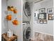 Laundry room with stacked washer and dryer and decor at 690 Island Way # 1003, Clearwater Beach, FL 33767
