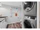 This laundry room has a modern washer and dryer, white cabinets, subway tile and luxury vinyl tile at 690 Island Way # 1003, Clearwater Beach, FL 33767