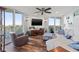 Bright living room with waterfront views, neutral decor, and wood floors at 690 Island Way # 1003, Clearwater Beach, FL 33767
