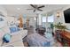 This well-lit living room has a dining area, wood floors, a ceiling fan, and access to the balcony at 690 Island Way # 1003, Clearwater Beach, FL 33767