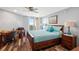 Well-lit bedroom featuring a king-sized bed, desk, and a sliding glass door that leads to a balcony at 690 Island Way # 1003, Clearwater Beach, FL 33767