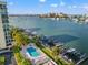 Scenic view of the waterfront condo with marina, pool, boat docks, and beautiful landscaping at 690 Island Way # 1003, Clearwater Beach, FL 33767