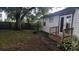 A backyard with a wooden deck and stairs, perfect for outdoor living at 7236 65Th N Way, Pinellas Park, FL 33781