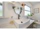 Well-lit bathroom featuring a modern vessel sink, stylish fixtures, and botanical prints for an elegant touch at 806 E New Orleans Ave, Tampa, FL 33603