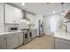 Well-lit kitchen with stainless steel appliances, subway tile backsplash, and light gray cabinetry at 806 E New Orleans Ave, Tampa, FL 33603