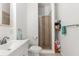 Clean and simple bathroom with white walls, a tiled shower, and modern fixtures at 8117 River Point Dr, Weeki Wachee, FL 34607