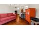 Living room with hardwood floors and a bright orange cabinet at 8117 River Point Dr, Weeki Wachee, FL 34607