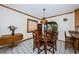 Dining area with hardwood table, chairs, and tile floors, bathed in warm light and classic charm at 8236 128Th St, Seminole, FL 33776