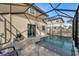 A screened-in pool and outdoor seating with grill provide a great space to unwind at 8297 Artisan Way, Seminole, FL 33777